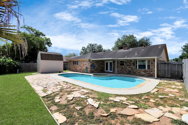 view of pool featuring a patio area, a lawn, and a storage unit