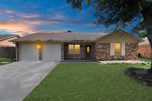 single story home featuring a garage and a lawn