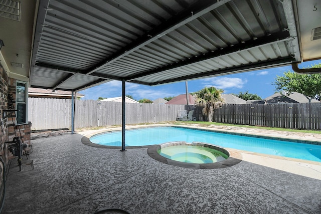 view of pool featuring a patio and an in ground hot tub