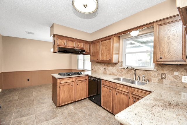 kitchen featuring stainless steel gas cooktop, sink, kitchen peninsula, backsplash, and dishwasher