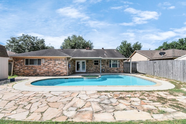 view of swimming pool featuring an in ground hot tub and a patio area