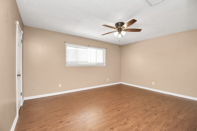 unfurnished room featuring dark hardwood / wood-style flooring, a textured ceiling, and ceiling fan