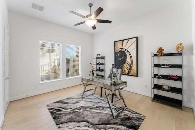 office space with light hardwood / wood-style floors and ceiling fan