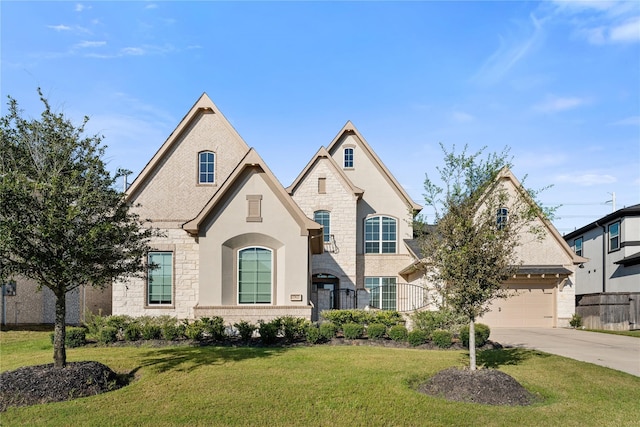 french country style house featuring a garage and a front yard