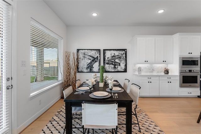 dining space with light hardwood / wood-style floors