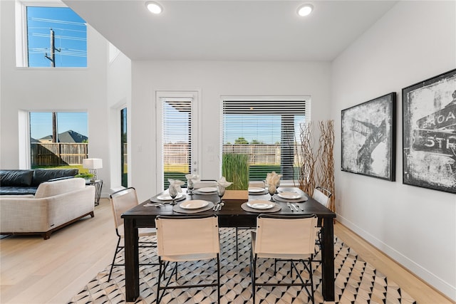 dining area with plenty of natural light and light hardwood / wood-style flooring