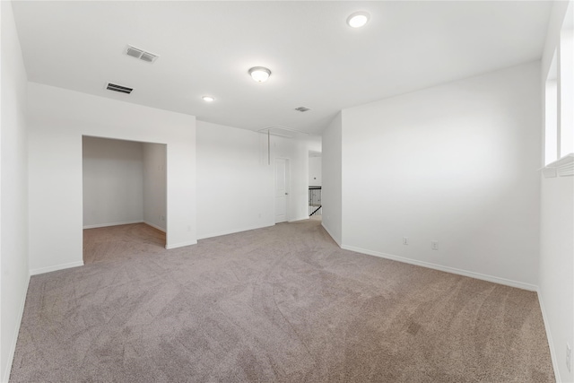 unfurnished room featuring light carpet