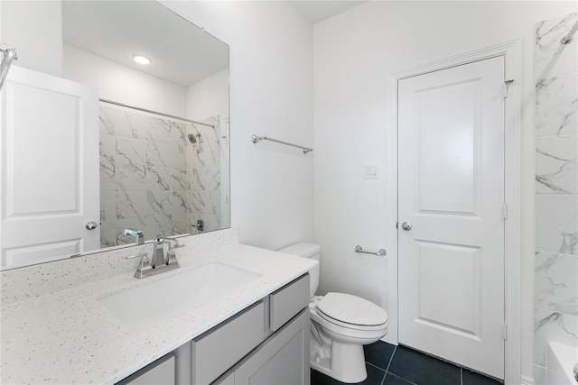 bathroom with toilet, vanity, and tile patterned floors