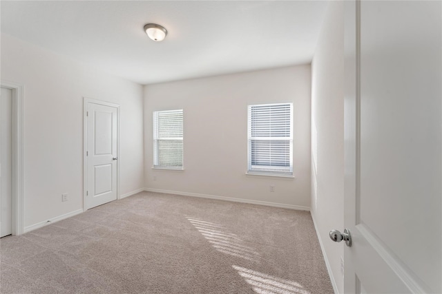 empty room featuring light colored carpet