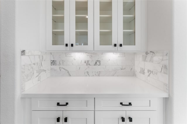 bar with white cabinets and tasteful backsplash