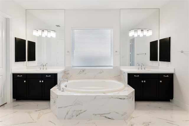 bathroom with vanity and tiled bath