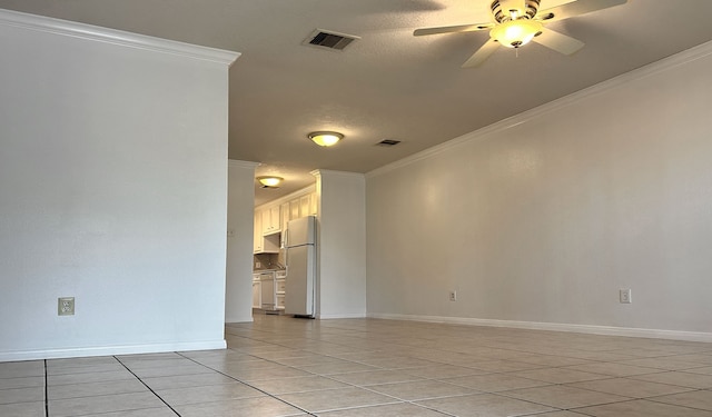 tiled spare room featuring a textured ceiling, ceiling fan, and crown molding