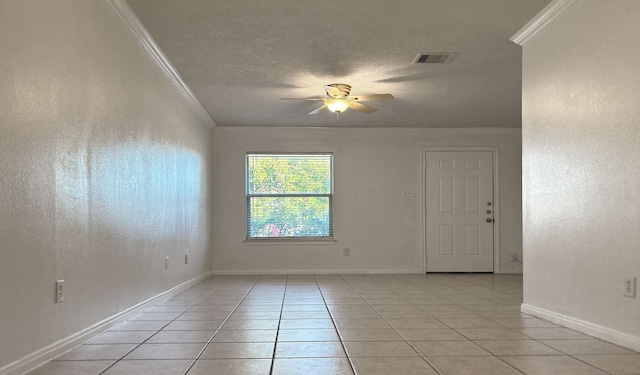 unfurnished room with ceiling fan, light tile patterned floors, a textured ceiling, and ornamental molding