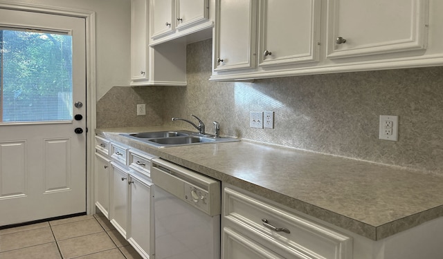 kitchen featuring backsplash, sink, light tile patterned floors, dishwasher, and white cabinetry