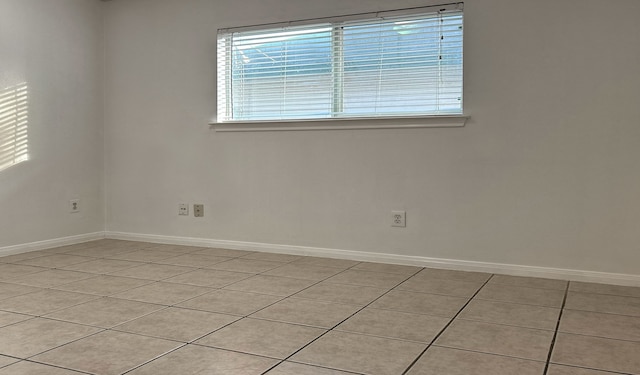 unfurnished room with light tile patterned floors