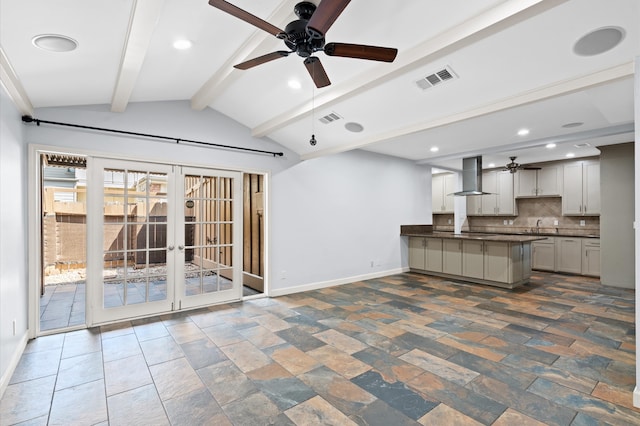 unfurnished living room with french doors, lofted ceiling with beams, and ceiling fan