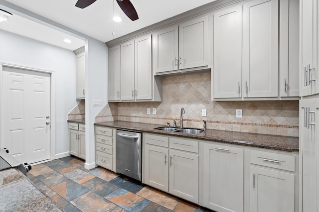 kitchen featuring tasteful backsplash, sink, dishwasher, dark stone countertops, and ceiling fan