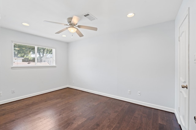 empty room featuring dark hardwood / wood-style flooring and ceiling fan