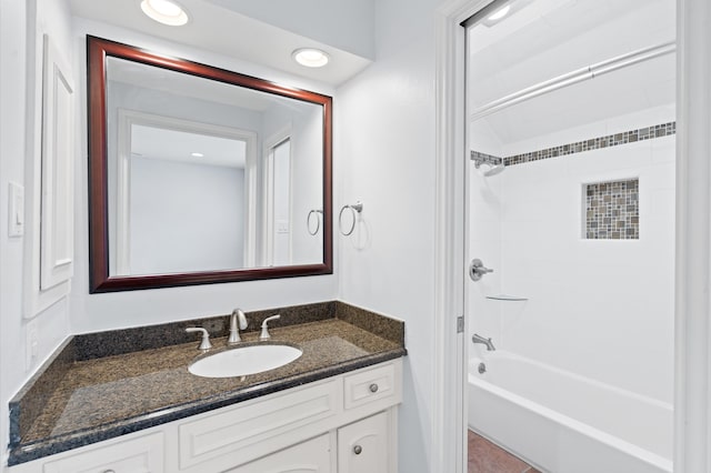 bathroom with vanity and tiled shower / bath combo