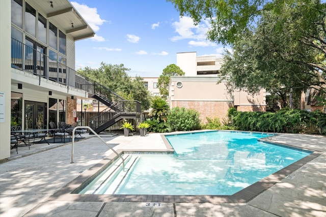 view of swimming pool with a patio area