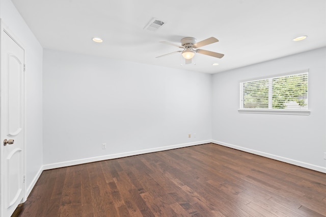 spare room featuring ceiling fan and dark hardwood / wood-style floors