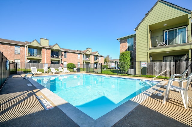 view of swimming pool with a patio