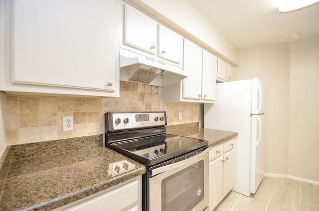 kitchen with white cabinetry, backsplash, white fridge, stainless steel range with electric stovetop, and light tile patterned flooring