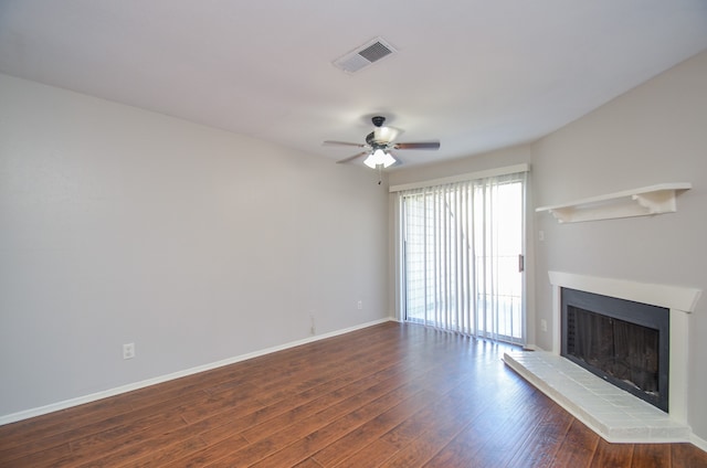 unfurnished living room with ceiling fan and dark wood-type flooring