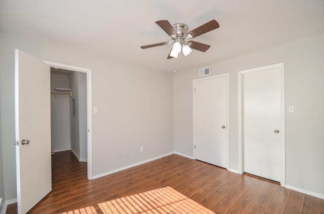 unfurnished bedroom featuring ceiling fan and dark wood-type flooring