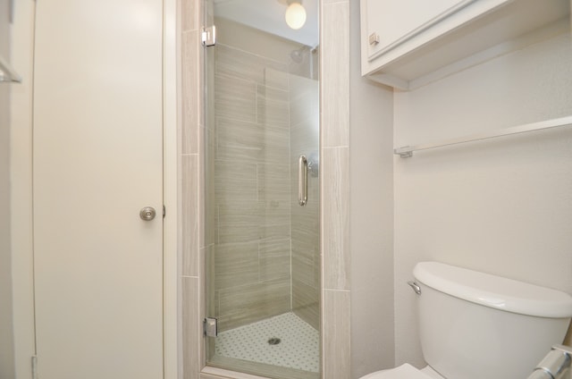 bathroom with toilet and walk in shower