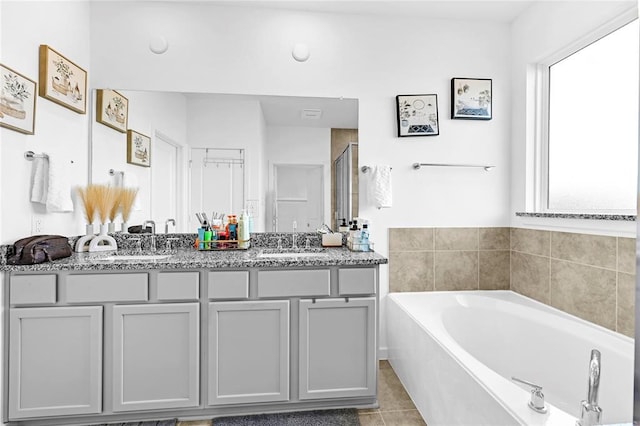 bathroom featuring separate shower and tub, tile patterned floors, and vanity