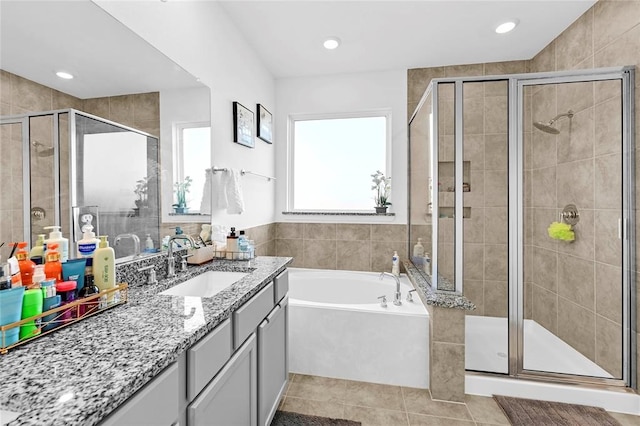 bathroom featuring tile patterned flooring, vanity, and separate shower and tub