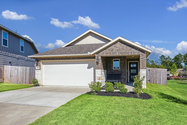 craftsman house with a garage and a front lawn