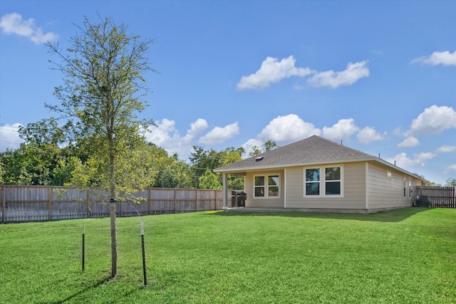 back of property featuring a yard