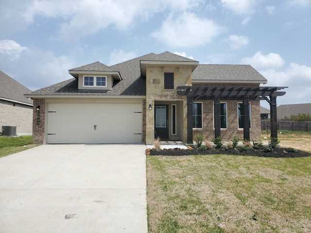 view of front of property with brick siding, a front lawn, concrete driveway, central AC unit, and a garage