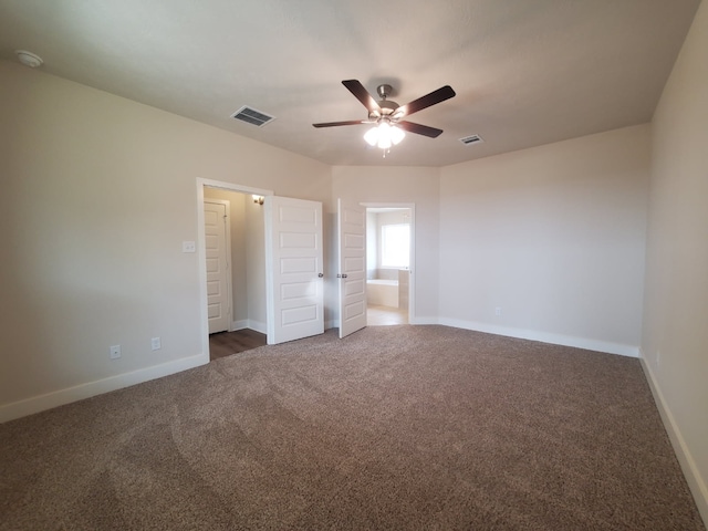 unfurnished bedroom with visible vents, ensuite bathroom, carpet, baseboards, and ceiling fan