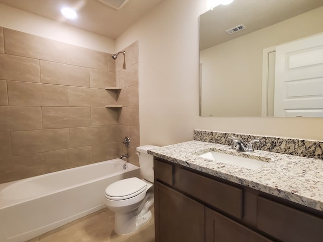 bathroom featuring visible vents, toilet, vanity, and bathing tub / shower combination