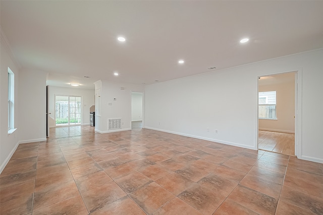 empty room with a wealth of natural light and ornamental molding