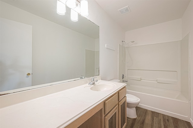 full bathroom featuring hardwood / wood-style flooring, vanity, toilet, and bathtub / shower combination