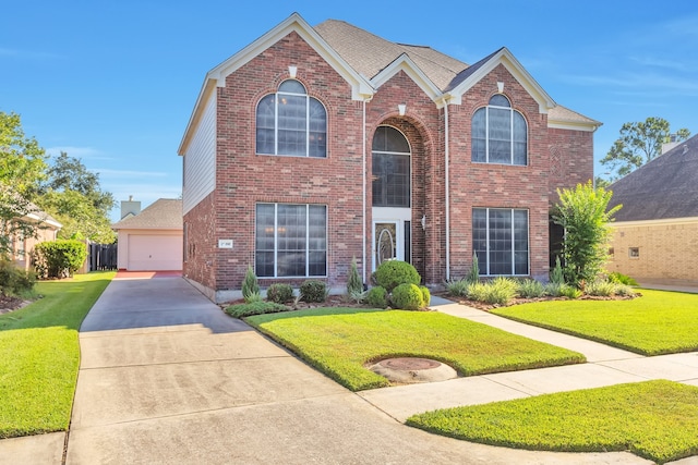 view of front property featuring a garage and a front yard