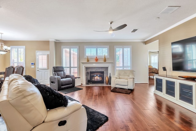 living room featuring ornamental molding, hardwood / wood-style floors, and plenty of natural light