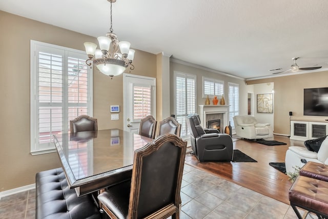 dining space featuring a wealth of natural light, light wood-type flooring, and crown molding