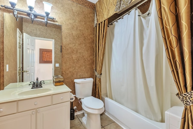 full bathroom featuring toilet, vanity, tile patterned floors, and shower / tub combo