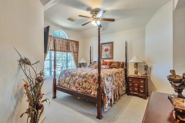 carpeted bedroom featuring ceiling fan, multiple windows, and vaulted ceiling