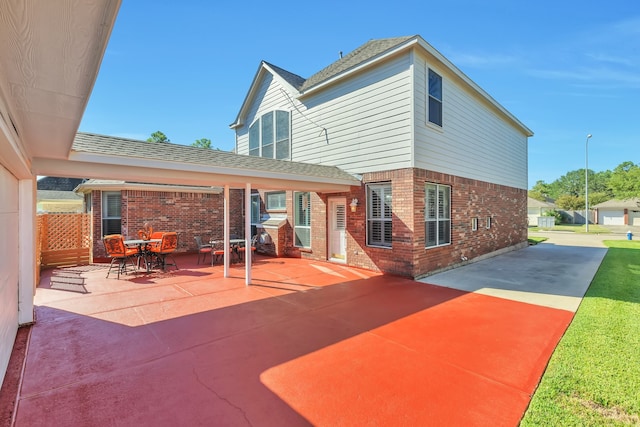 rear view of house with a yard and a patio