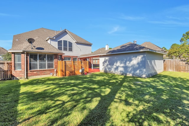 rear view of property with a lawn and a patio