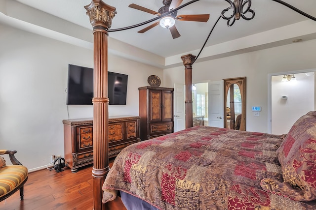 bedroom with ornate columns, hardwood / wood-style floors, and ceiling fan