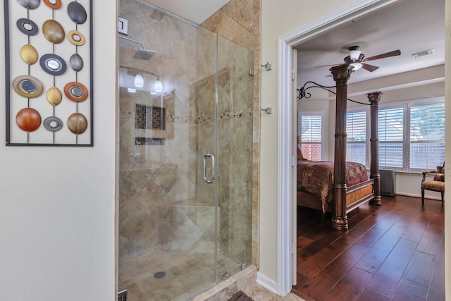 bathroom with ceiling fan, walk in shower, and wood-type flooring