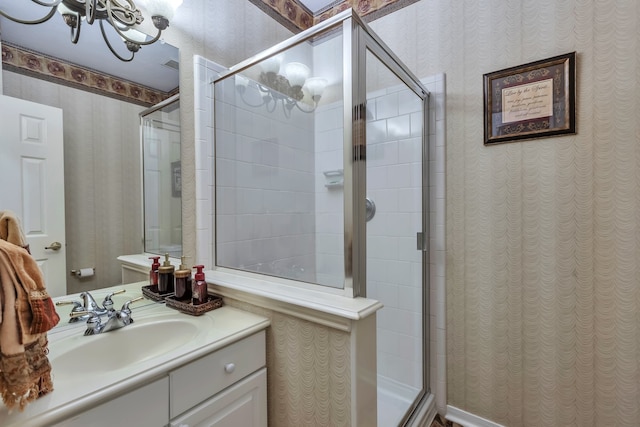 bathroom with walk in shower and vanity