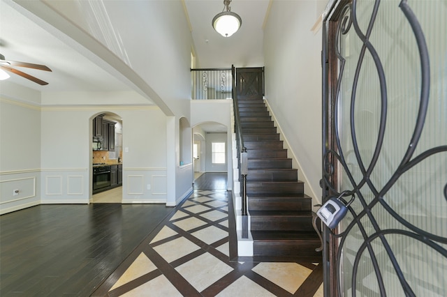 foyer entrance featuring ornamental molding, a barn door, and hardwood / wood-style flooring